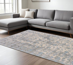 10' X 13' Ivory Taupe and Blue Abstract Power Loom Worn Faded Area Rug